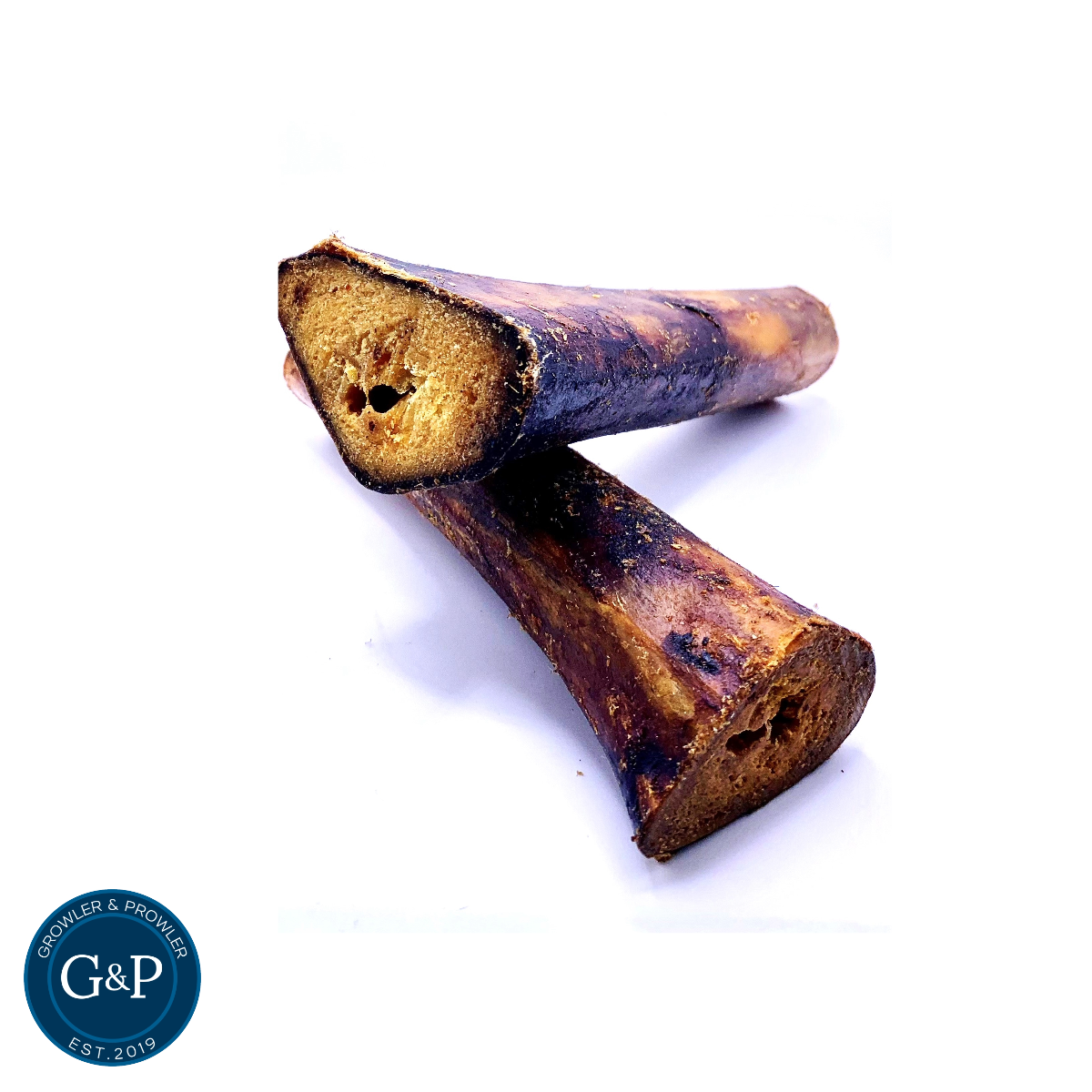 A long, hollow ostrich bone, perfect for dogs to chew on. It's filled with nutritious marrow and is labeled as an "Ostrich Marrow Bone" from Growler & Prowler.