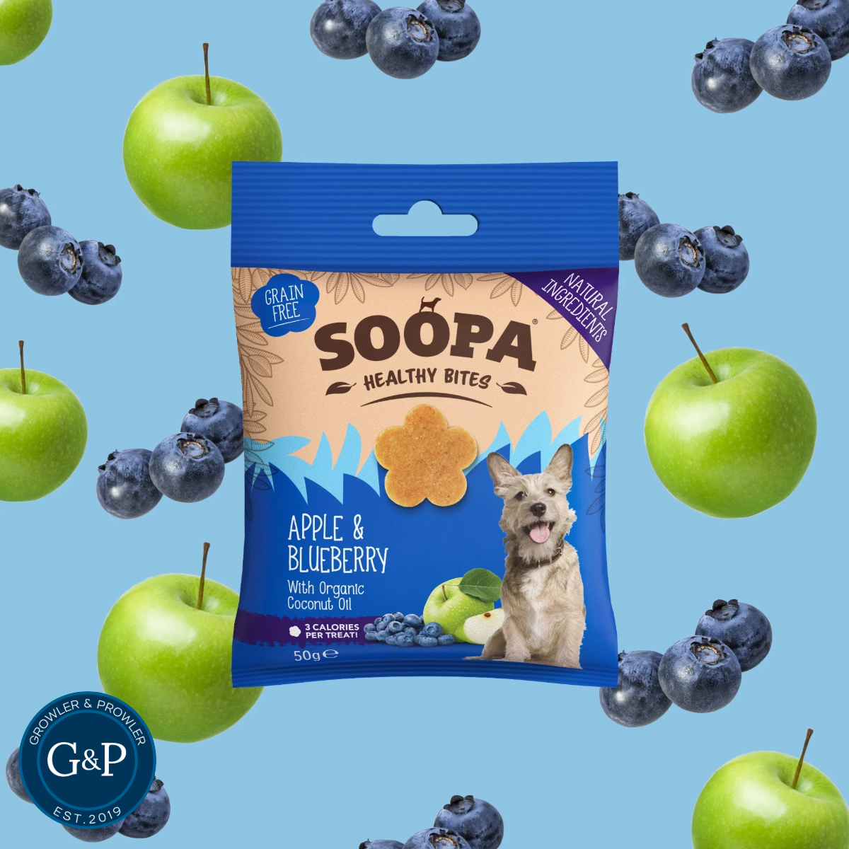 A bag of Soopa Apple & Blueberry Healthy Bites dog treats, surrounded by apples and blueberries. Made with natural ingredients and perfect for healthy snacking.