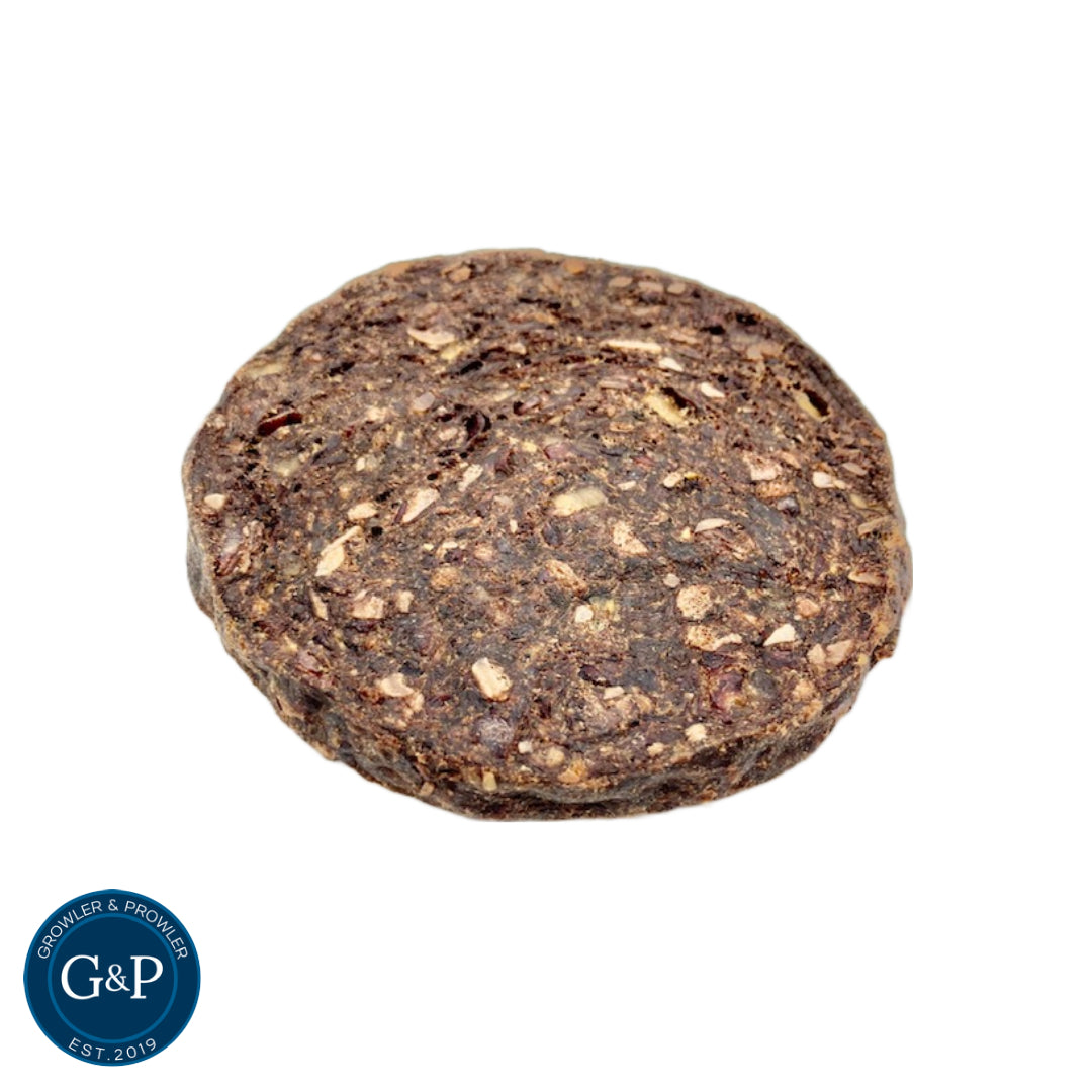 A round, dark brown Growler and Prowler Quarter Pounder Burger made with pure chicken and pork, and 100% natural ingredients.